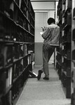 Student in library stacks
